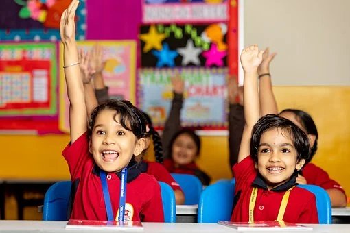 Students raising hands in a classroom